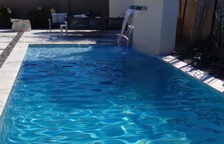 Universal Mini Pebble - Lakeside pool with water feature and seating area